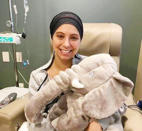 female patient holding a stuffed elephant
